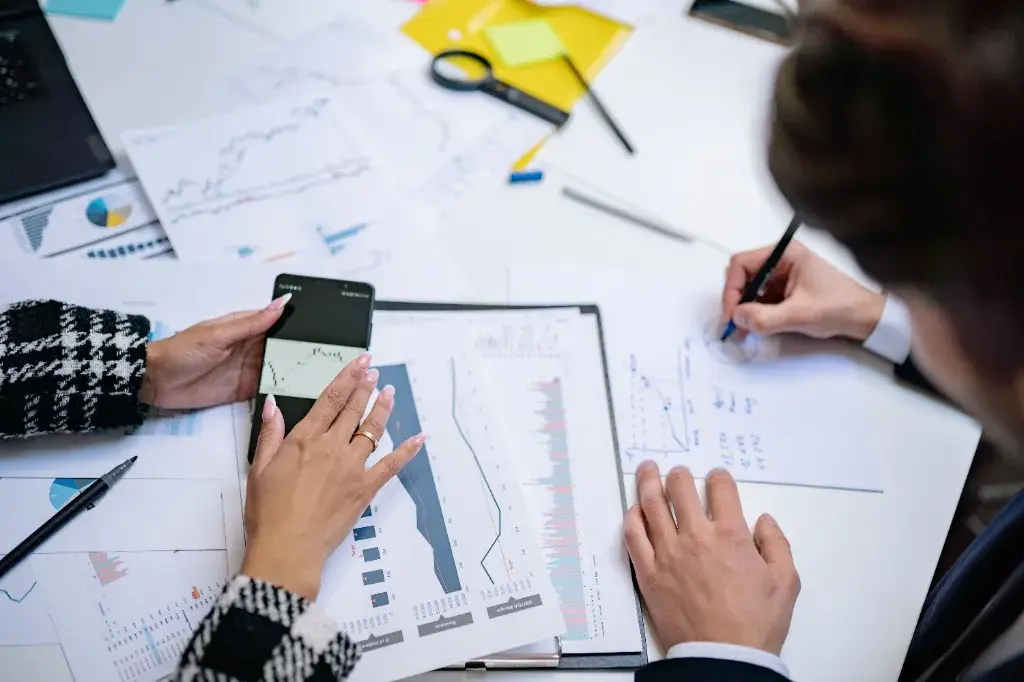 Analysts reviewing financial charts, statements, and loss documentation